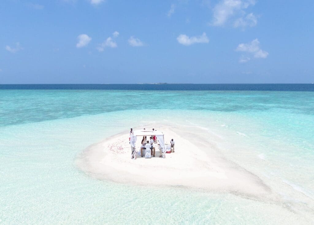 An Aerial Photography of a Wedding Ceremony at the Beach